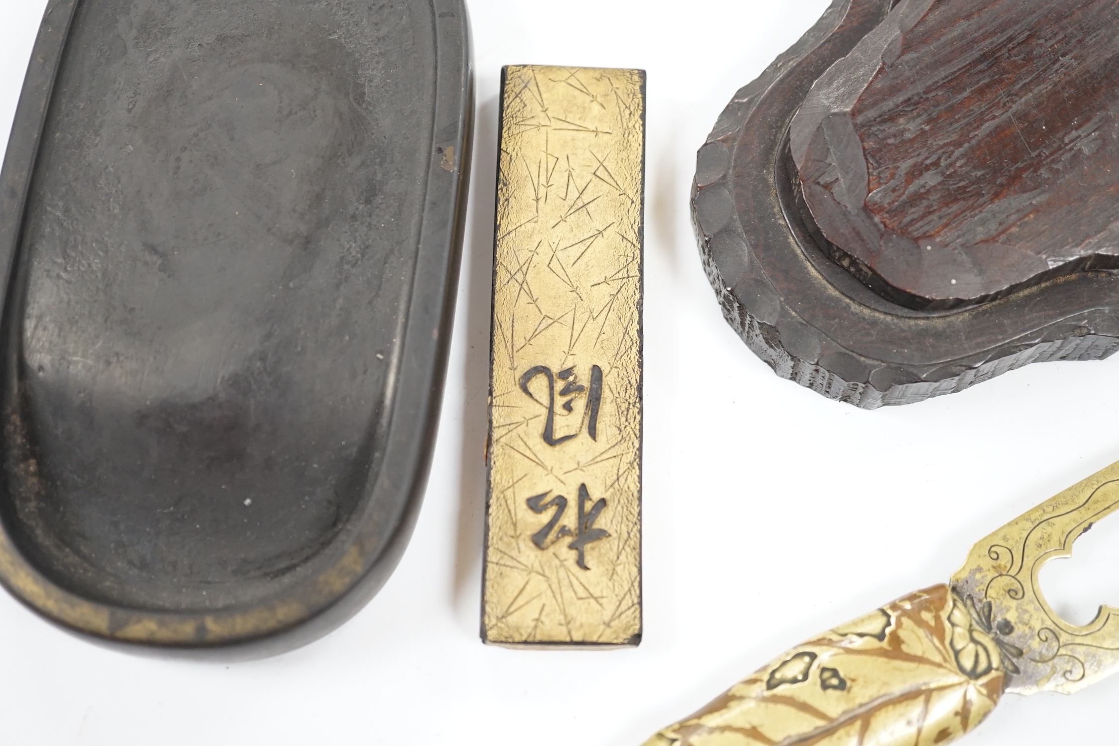 Literati interest: a Chinese red lacquer writing box, 26.5 x 24 x 6.5cm, with two inkstones, a brass paper cutter and ink cake. Condition - fair, some damage to edges and corners of the box